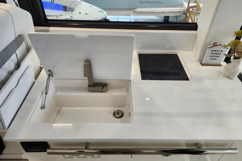 Slide: The Image of Modern kitchen area in 2025 Regal 36 XO yacht with sink and induction cooktop. - 25