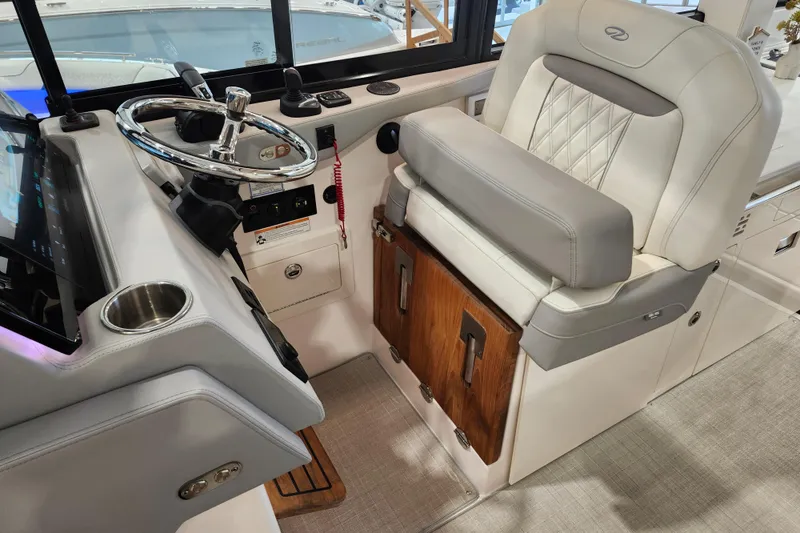 Slide: The Image of Luxury helm of 2025 Regal 36 XO boat with plush seating and modern controls. - 28