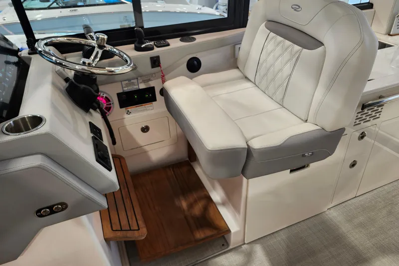 Slide: The Image of Captain's seat and helm of 2025 Regal 36 XO boat, featuring modern controls and luxurious design. - 29