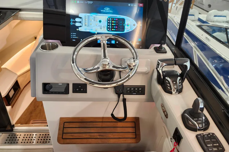 Slide: The Image of 2025 Regal 36 XO boat helm with modern controls and touchscreen display. - 30