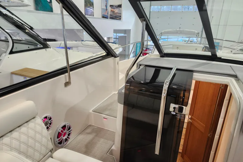 Slide: The Image of 2025 Regal 36 XO boat interior with modern seating and cabin entrance. - 33