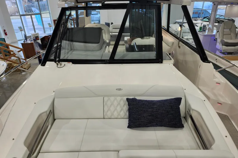 Slide: The Image of 2025 Regal 36 XO boat interior with white seating and blue cushion. - 37