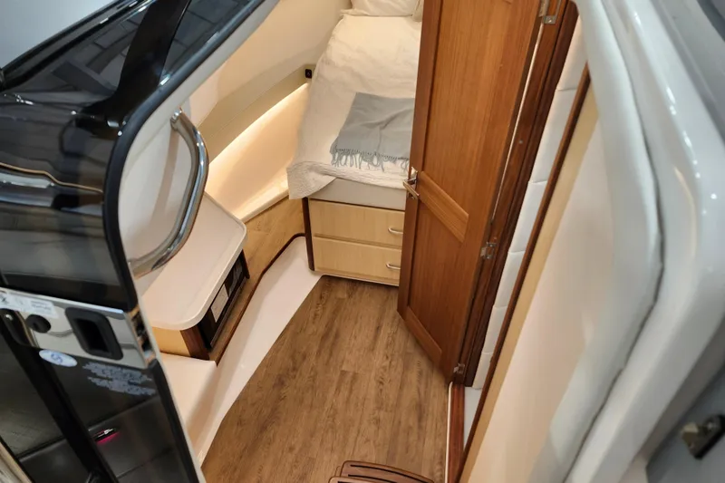 Slide: The Image of 2025 Regal 36 XO yacht interior with wood flooring and cozy sleeping area. - 42