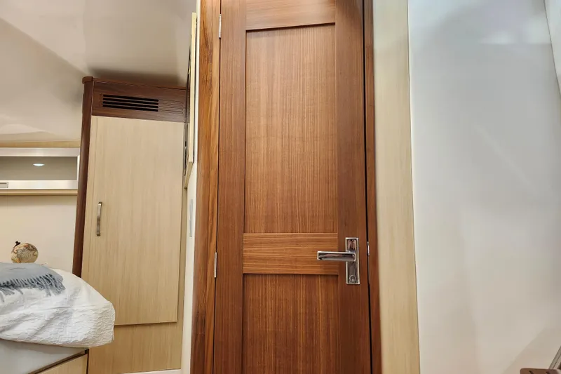 Slide: The Image of Interior of 2025 Regal 36 XO yacht featuring wooden door and modern furnishings. - 46