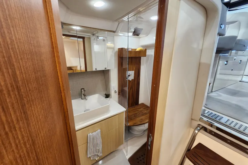 Slide: The Image of Luxurious bathroom interior of 2025 Regal 36 XO yacht with modern fixtures and wood accents. - 47