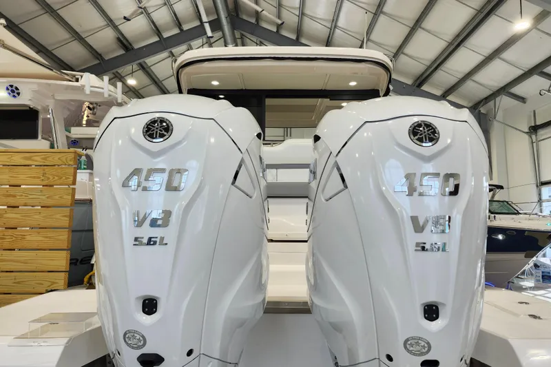 Slide: The Image of 2025 Regal 36 XO boat with dual 450 V8 5.6L engines in a showroom. - 7