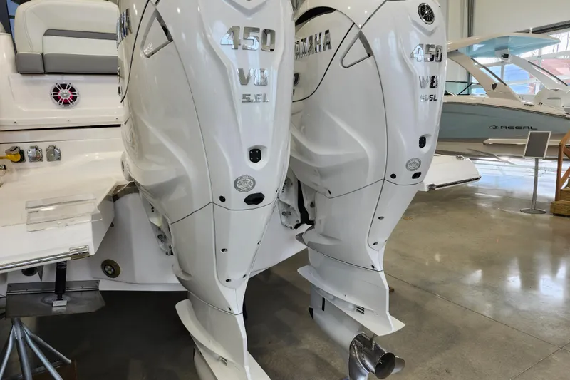 Slide: The Image of 2025 Regal 36 XO boat with twin Yamaha 450 V8 outboard engines in showroom. - 8