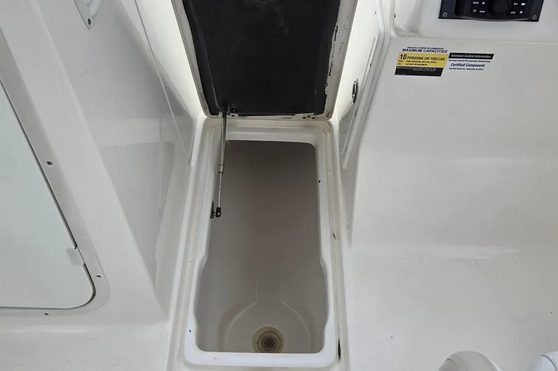 Slide: The Image of Open storage compartment on 2020 Key West 239 DFS boat, showing interior space. - 11
