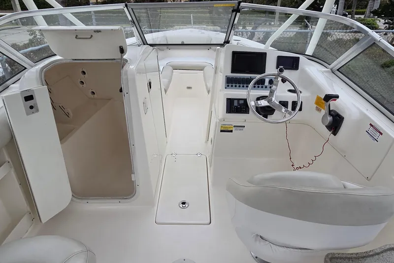 Slide: The Image of 2020 Key West 239 DFS boat interior with steering wheel and control panel. - 13
