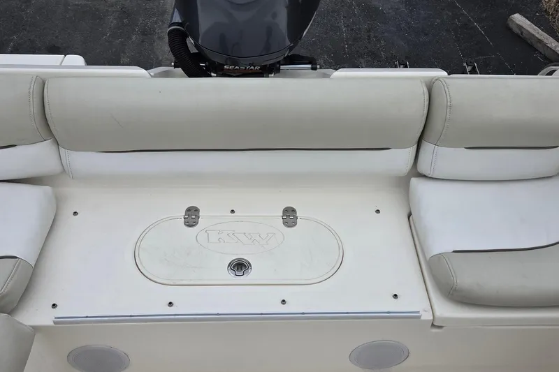 Slide: The Image of 2020 Key West 239 DFS boat seating area with storage compartment and engine view. - 4