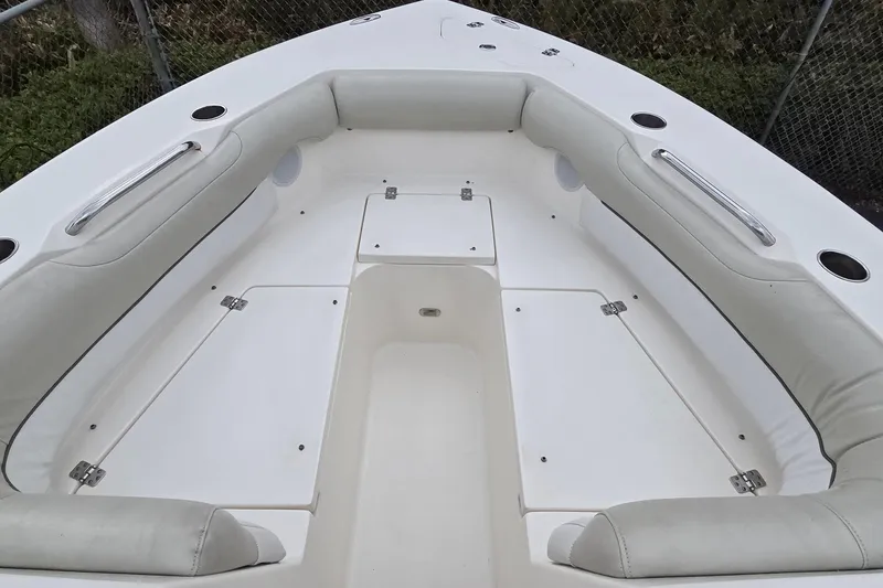 Slide: The Image of 2020 Key West 239 DFS boat interior with cushioned seating and storage compartments. - 7