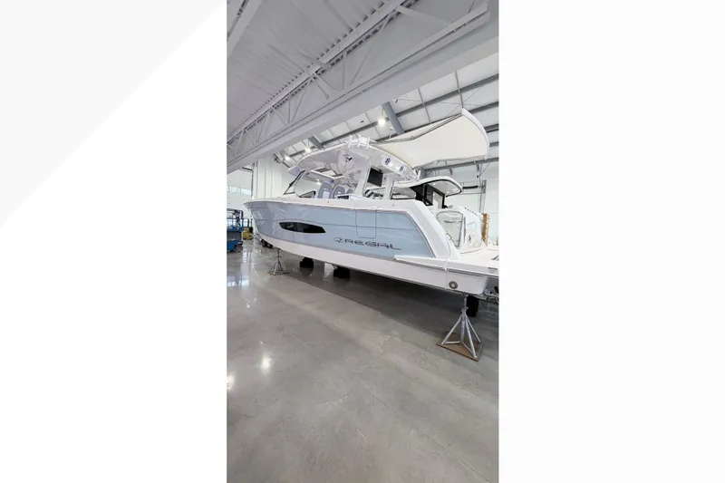 The Image of 2026 Regal 38 SAV luxury boat displayed in a showroom. - 0