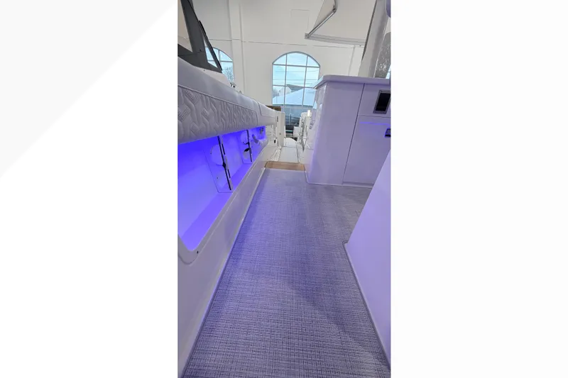 Slide: The Image of Interior view of 2026 Regal 38 SAV boat, featuring sleek white cabinetry and modern design. - 11