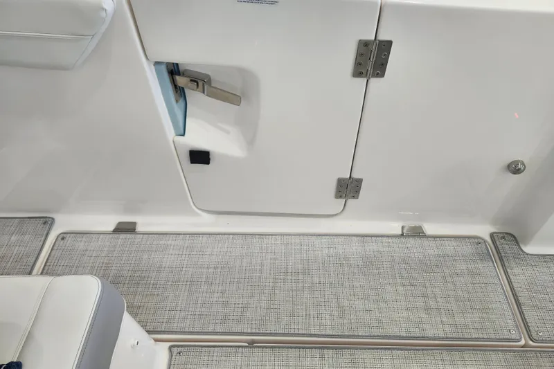 Slide: The Image of Interior view of 2026 Regal 38 SAV boat, featuring sleek white paneling and textured flooring. - 17