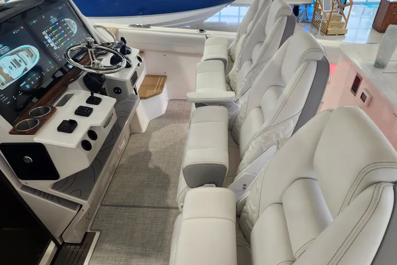 Slide: The Image of Luxurious interior of 2026 Regal 38 SAV boat with modern dashboard and plush seating. - 18