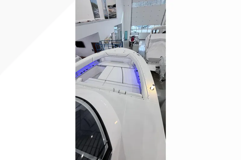 Slide: The Image of 2026 Regal 38 SAV boat in showroom, showcasing sleek design and modern features. - 2