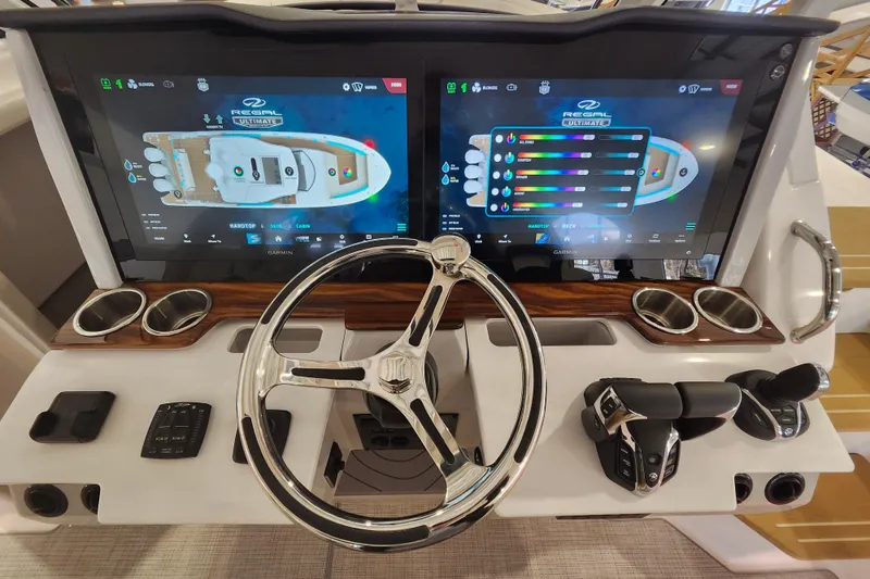 Slide: The Image of Helm of 2026 Regal 38 SAV boat with dual touchscreen displays and controls. - 22