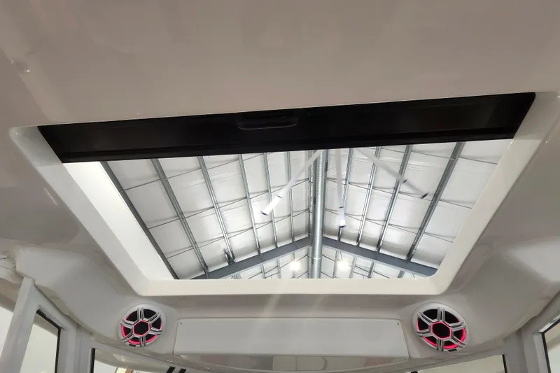 Slide: The Image of 2026 Regal 38 SAV boat interior with sunroof and speakers. - 23