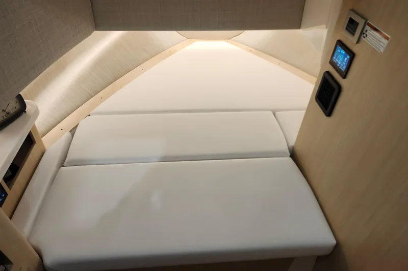 Slide: The Image of Interior cabin of 2026 Regal 38 SAV boat with cushioned seating and control panel. - 25