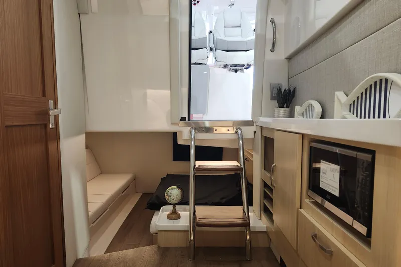 Slide: The Image of Interior of 2026 Regal 38 SAV yacht featuring modern kitchen and seating area. - 26
