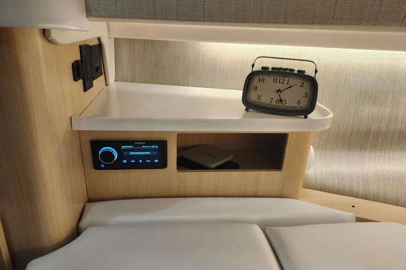Slide: The Image of Cozy cabin interior of 2026 Regal 38 SAV with vintage clock and modern audio system. - 28