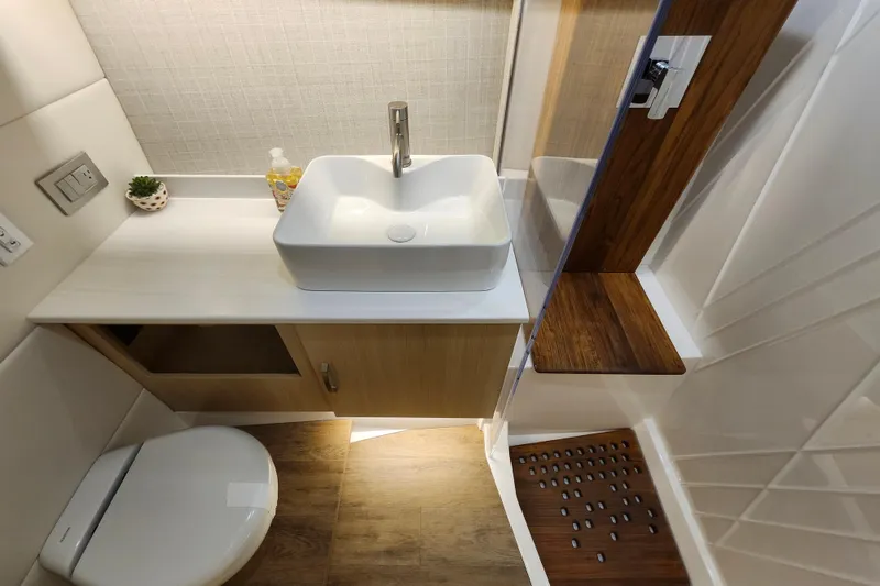 Slide: The Image of Luxurious bathroom interior of 2026 Regal 38 SAV yacht with modern sink and wooden accents. - 31