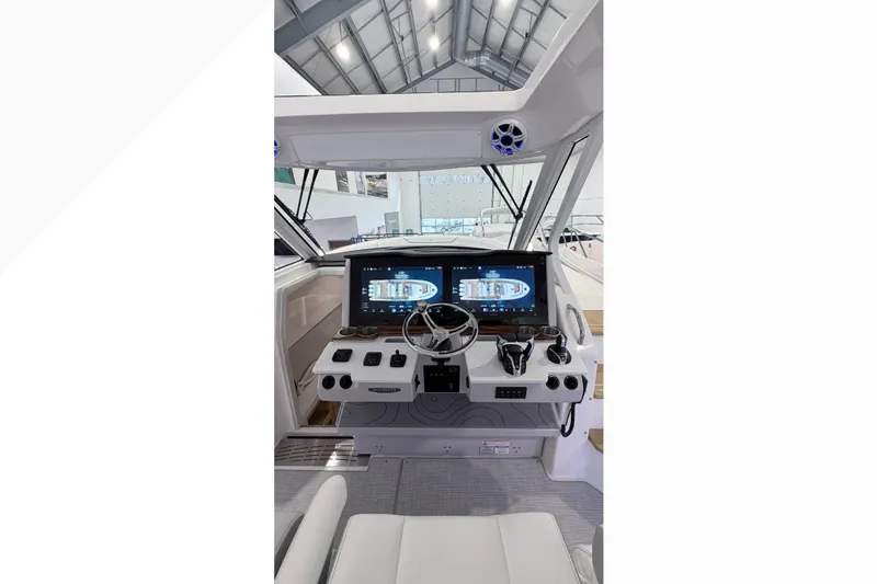 Slide: The Image of 2026 Regal 38 SAV boat interior with cushioned seating and decorative pillows. - 4