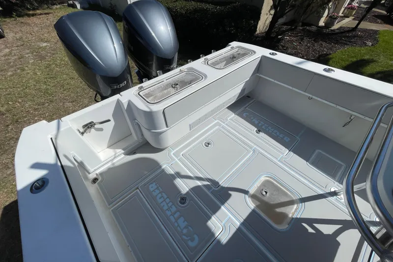 Slide: The Image of 2008 Contender 27 Tournament boat with T-top and rod holders, parked outdoors. - 12