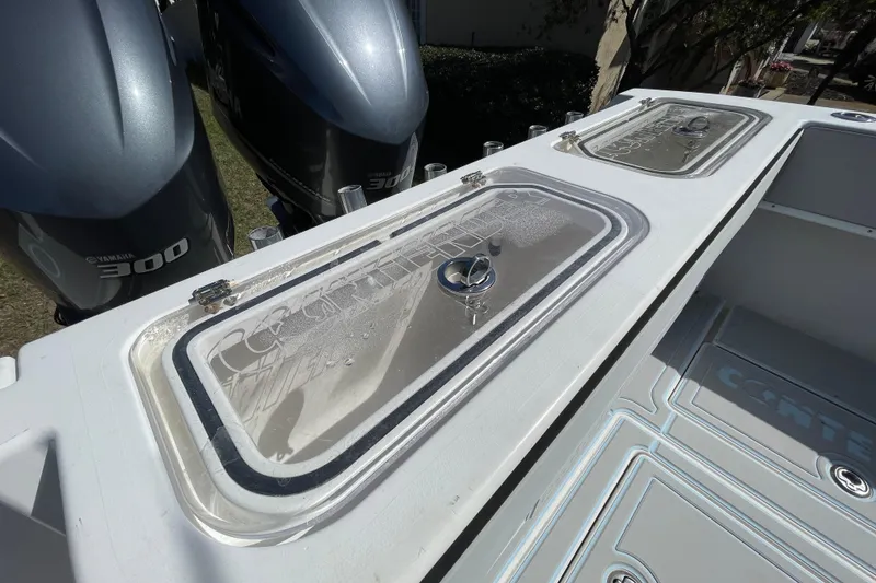 Slide: The Image of 2008 Contender 27 Tournament boat deck with seating and storage compartments. - 13