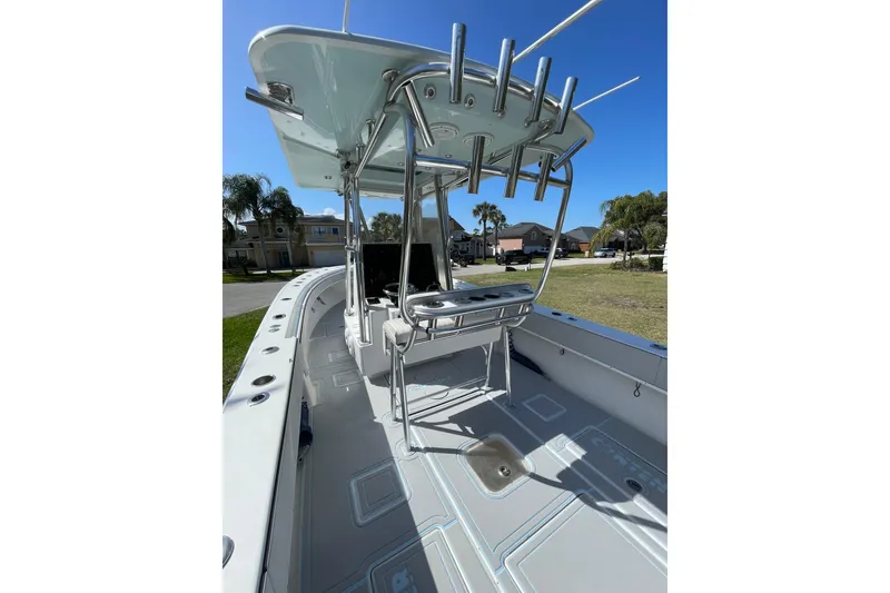 Slide: The Image of 2008 Contender 27 Tournament boat, top view, in a yard with trees and palm. - 14