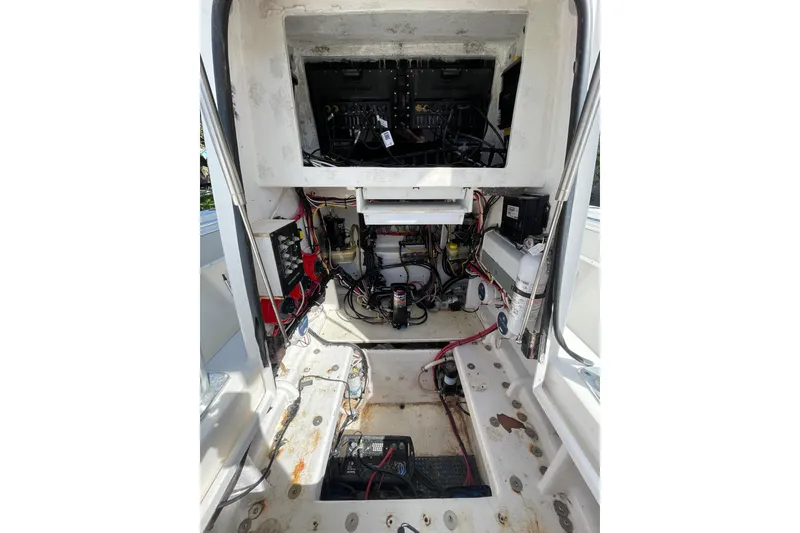 Slide: The Image of 2008 Contender 27 Tournament boat on trailer, parked in a grassy yard. - 23