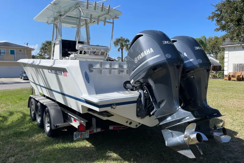 Slide: The Image of 2008 Contender 27 Tournament boat on trailer in residential yard. - 6