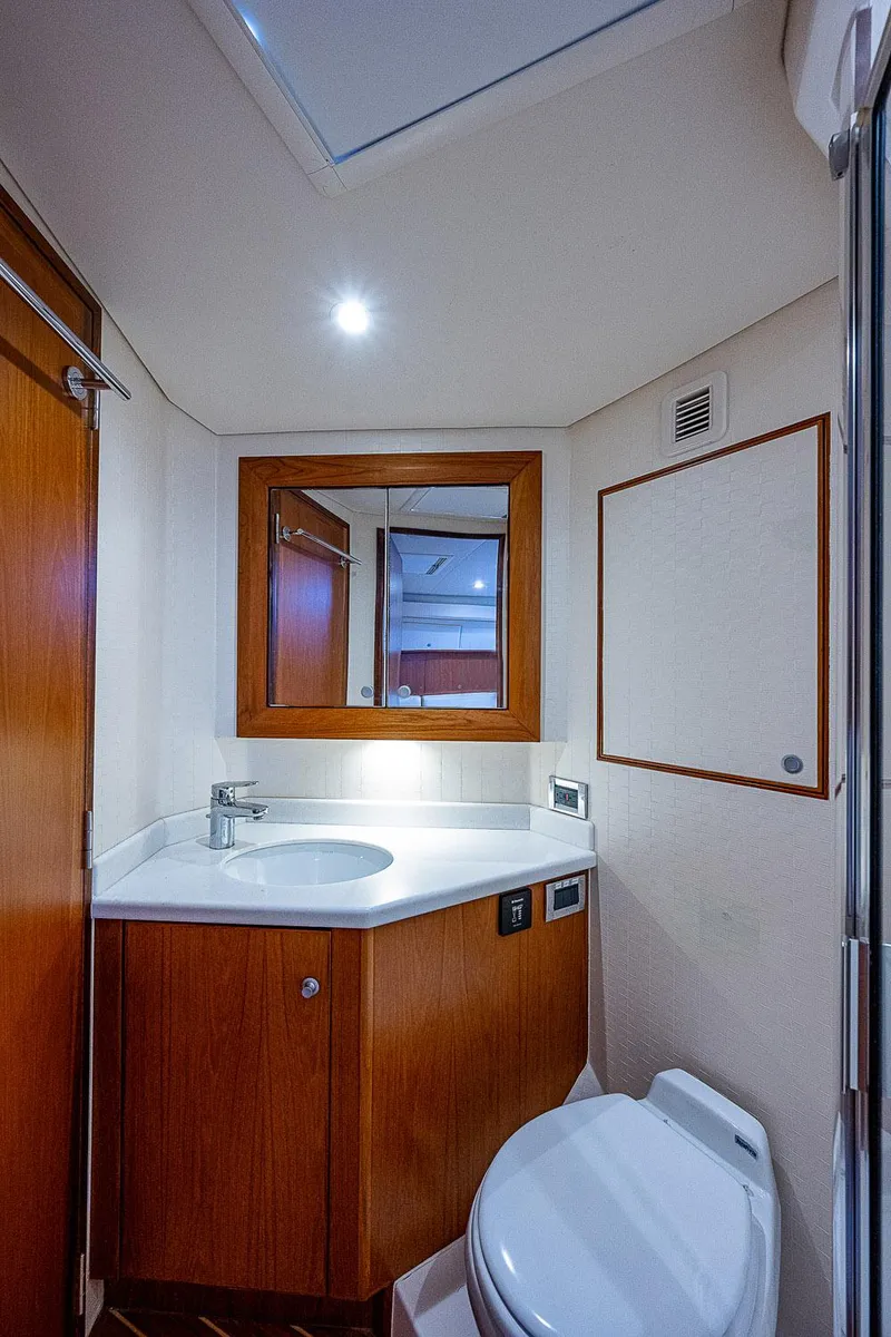 Slide: The Image of Luxurious bathroom interior of 2012 Cabo 44 HTX yacht with modern fixtures and wooden cabinetry. - 15