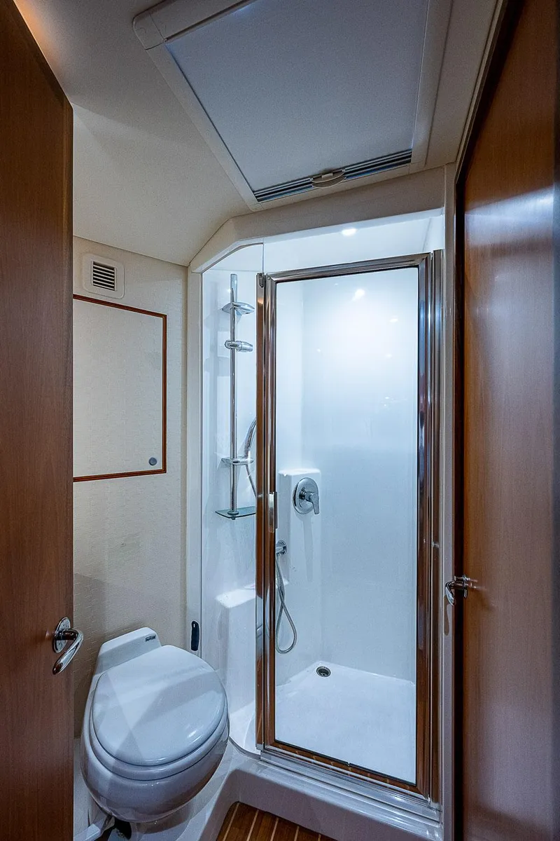 Slide: The Image of Luxurious bathroom in 2012 Cabo 44 HTX yacht with shower and toilet. - 16