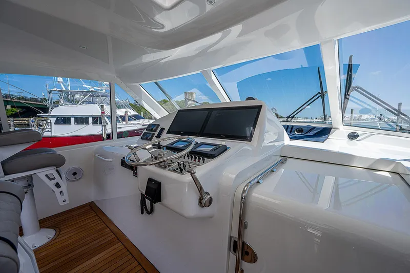 Slide: The Image of Interior view of 2012 Cabo 44 HTX yacht cockpit with modern navigation equipment. - 21
