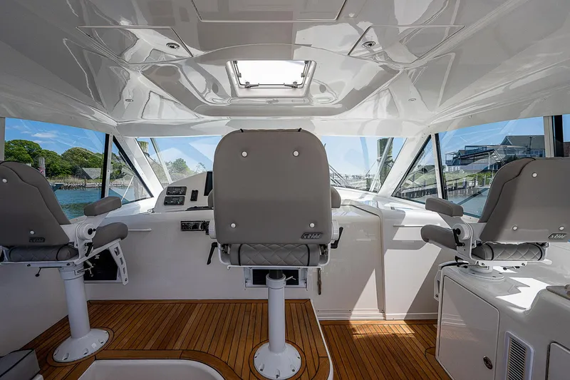 Slide: The Image of Interior of 2012 Cabo 44 HTX yacht with modern helm and seating. - 22
