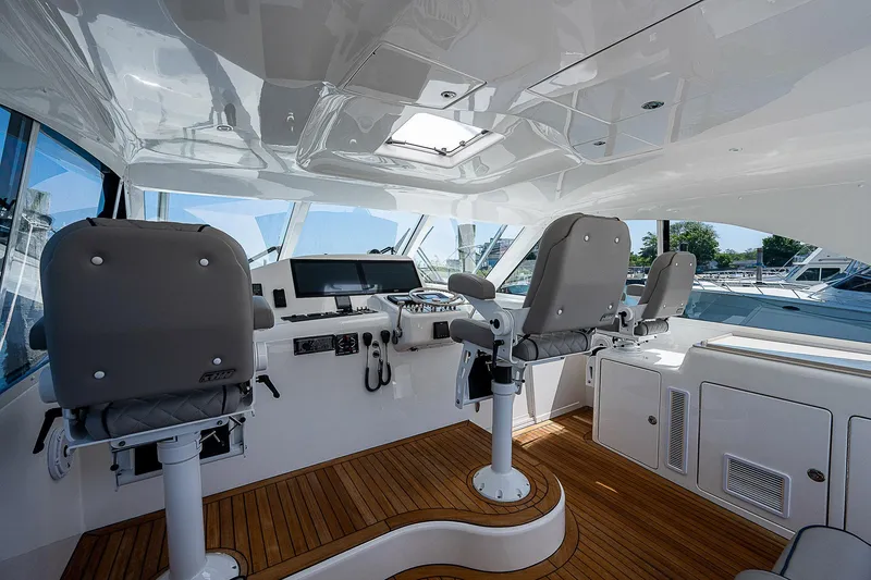 Slide: The Image of Interior of 2012 Cabo 44 HTX yacht with helm station and seating. - 26