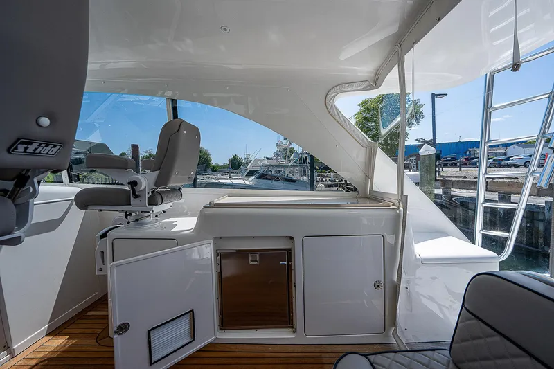 Slide: The Image of Interior view of 2012 Cabo 44 HTX yacht with seating and storage. - 27