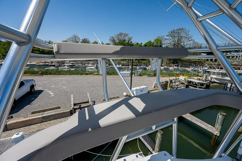 Slide: The Image of Cabo 44 HTX 2012 boat with sleek metal framework and marina view. - 34