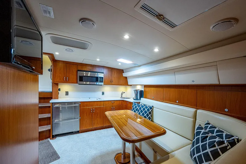 Slide: The Image of Luxurious interior of 2012 Cabo 44 HTX yacht with modern kitchen and seating area. - 4