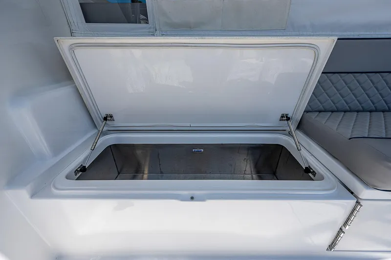 Slide: The Image of Open storage compartment on a 2012 Cabo 44 HTX boat interior. - 43