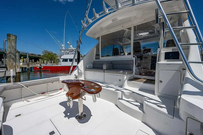 Slide: The Image of 2012 Cabo 44 HTX yacht deck with seating and fishing station. - 45