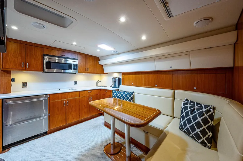 Slide: The Image of Luxurious interior of 2012 Cabo 44 HTX yacht with modern kitchen and seating area. - 6