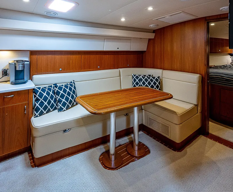 Slide: The Image of Luxurious interior of 2012 Cabo 44 HTX yacht with cozy seating and wooden table. - 8