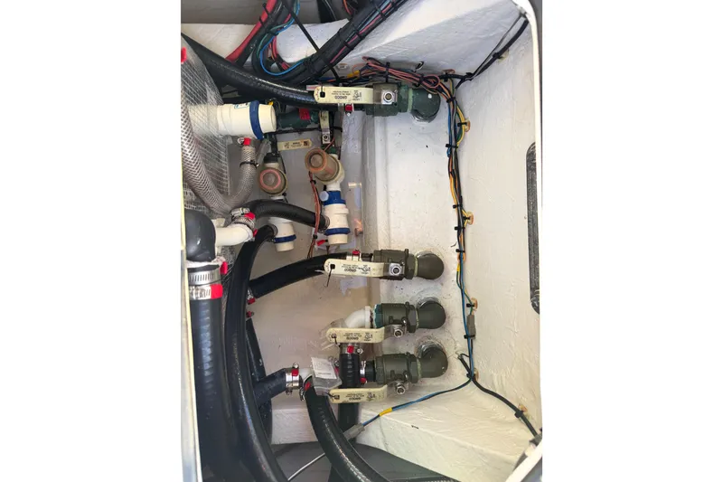 Slide: The Image of 2021 Hewes Redfisher 21 boat plumbing system with hoses and valves. - 10