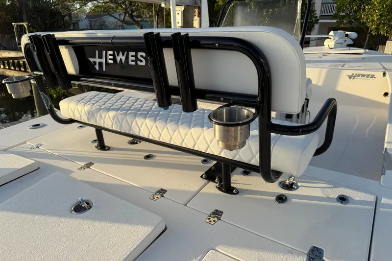 Slide: The Image of 2021 Hewes Redfisher 21 boat interior with cushioned seating and cup holders. - 12