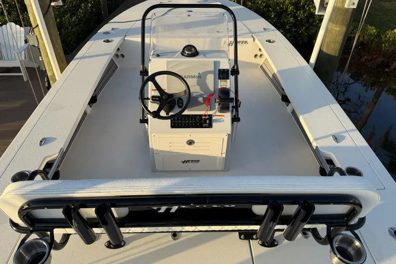 Slide: The Image of 2021 Hewes Redfisher 21 boat interior with steering console and rod holders. - 13