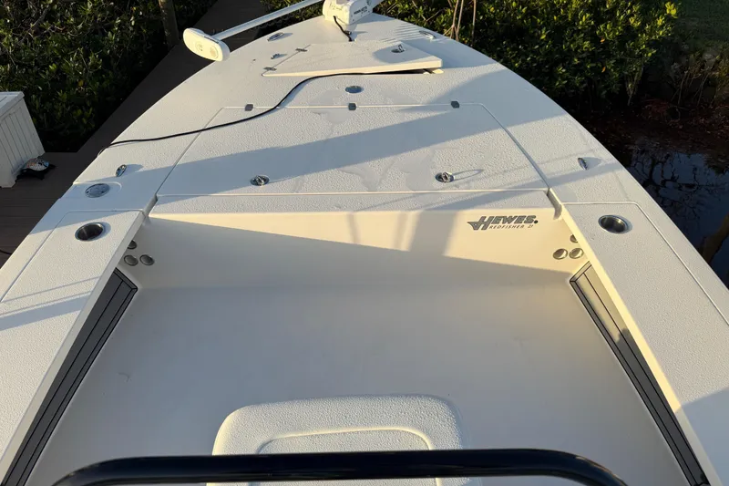 Slide: The Image of 2021 Hewes Redfisher 21 boat deck with storage compartments and rod holders. - 14