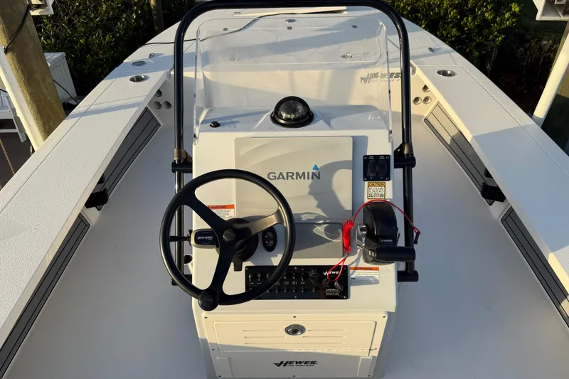 Slide: The Image of 2021 Hewes Redfisher 21 boat console with Garmin navigation system and steering wheel. - 16