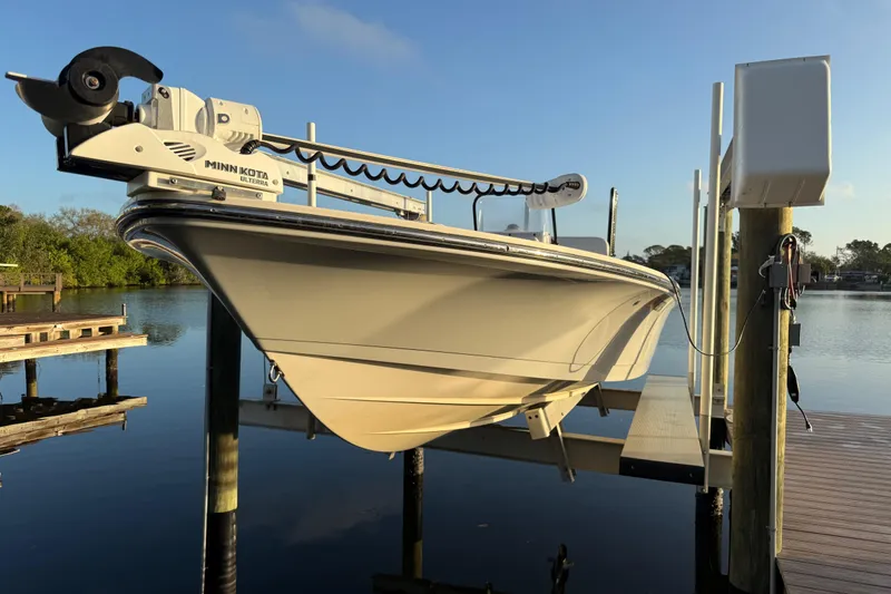 Slide: The Image of 2021 Hewes Redfisher 21 boat on lift, equipped with Minn Kota Ulterra motor. - 17